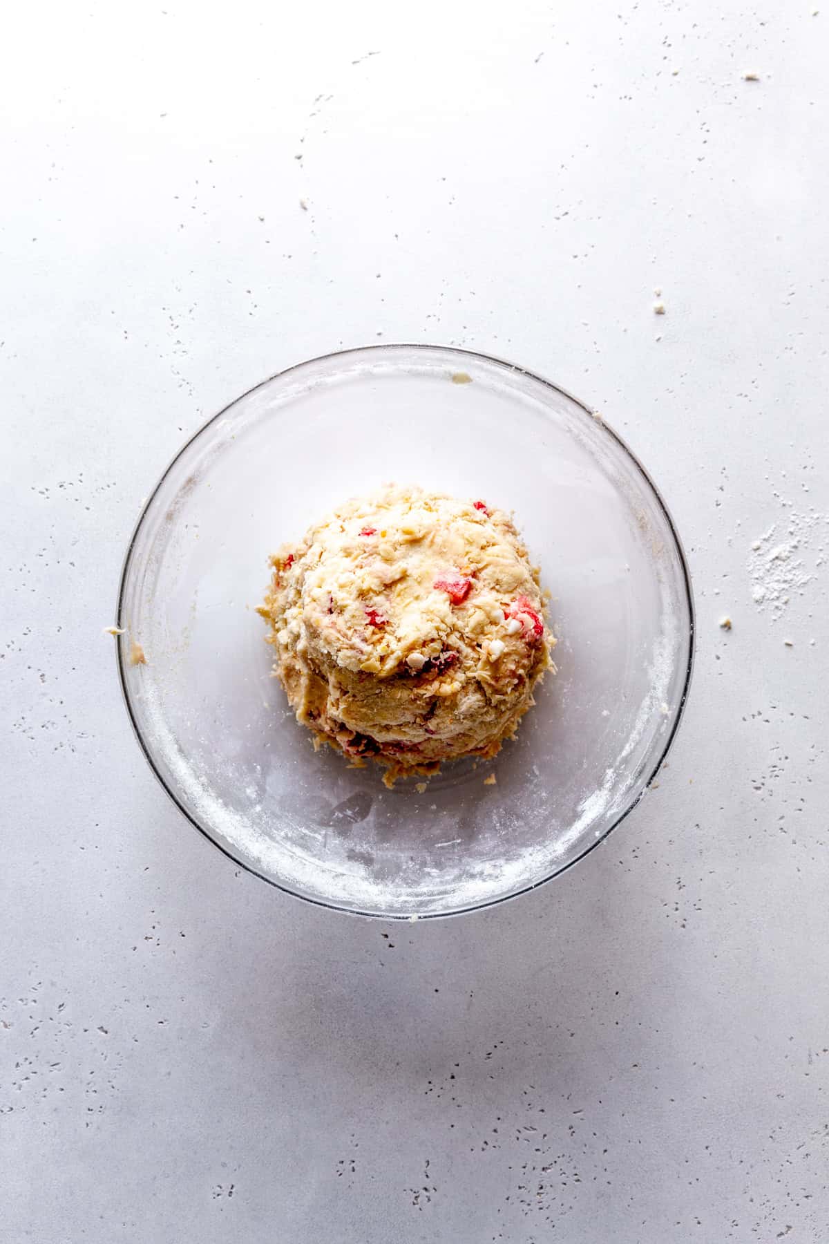 Glass bowl of strawberry rhubarb scone dough.