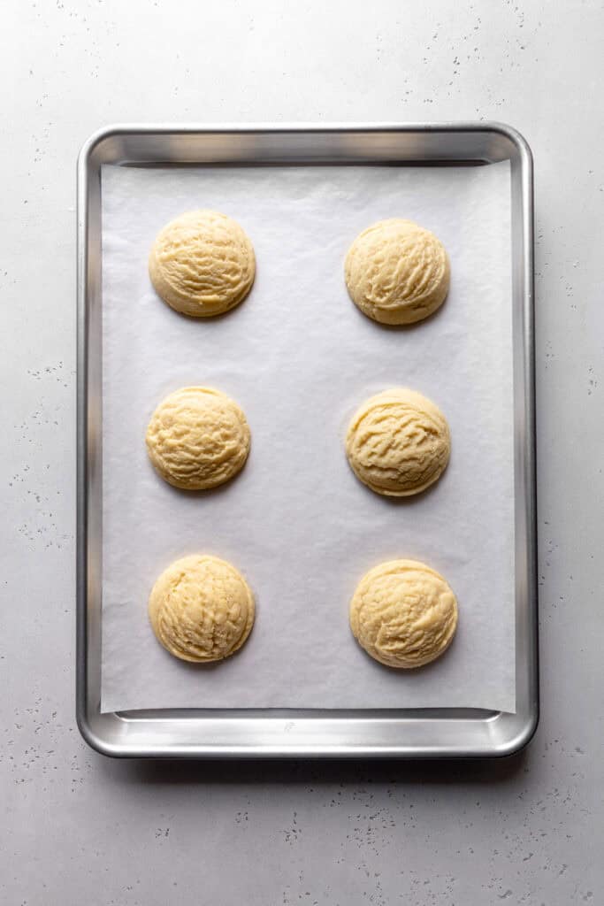 Baked sugar cookies on a baking sheet.