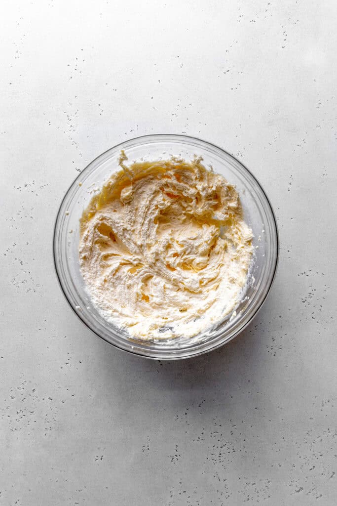 Glass bowl of creamed butter and sugar.