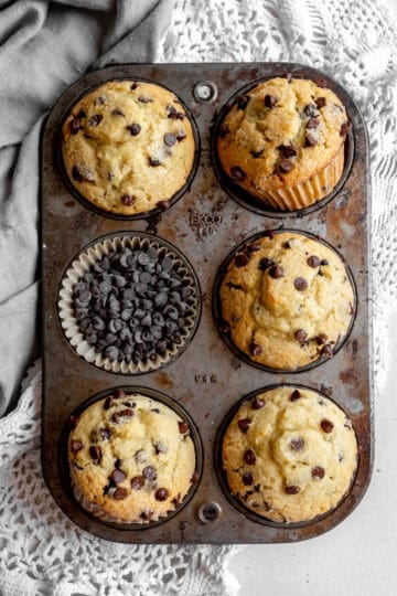 Pan full of chocolate chip muffins and a gray linen napkin.