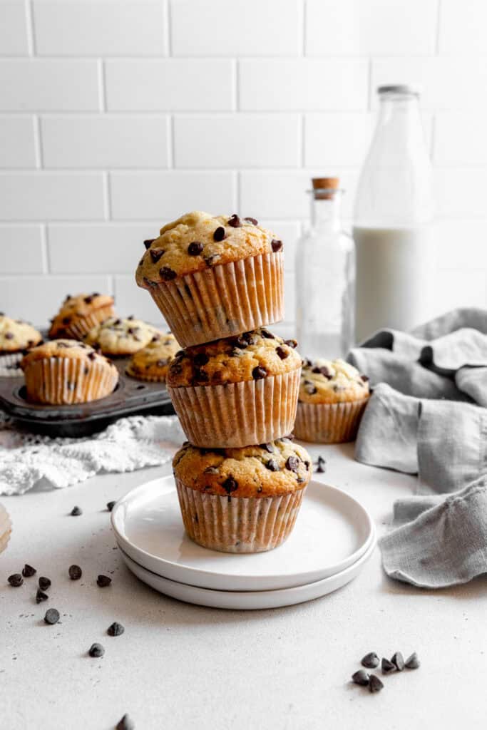 Stack of chocolate chip muffins and a jug of milk.