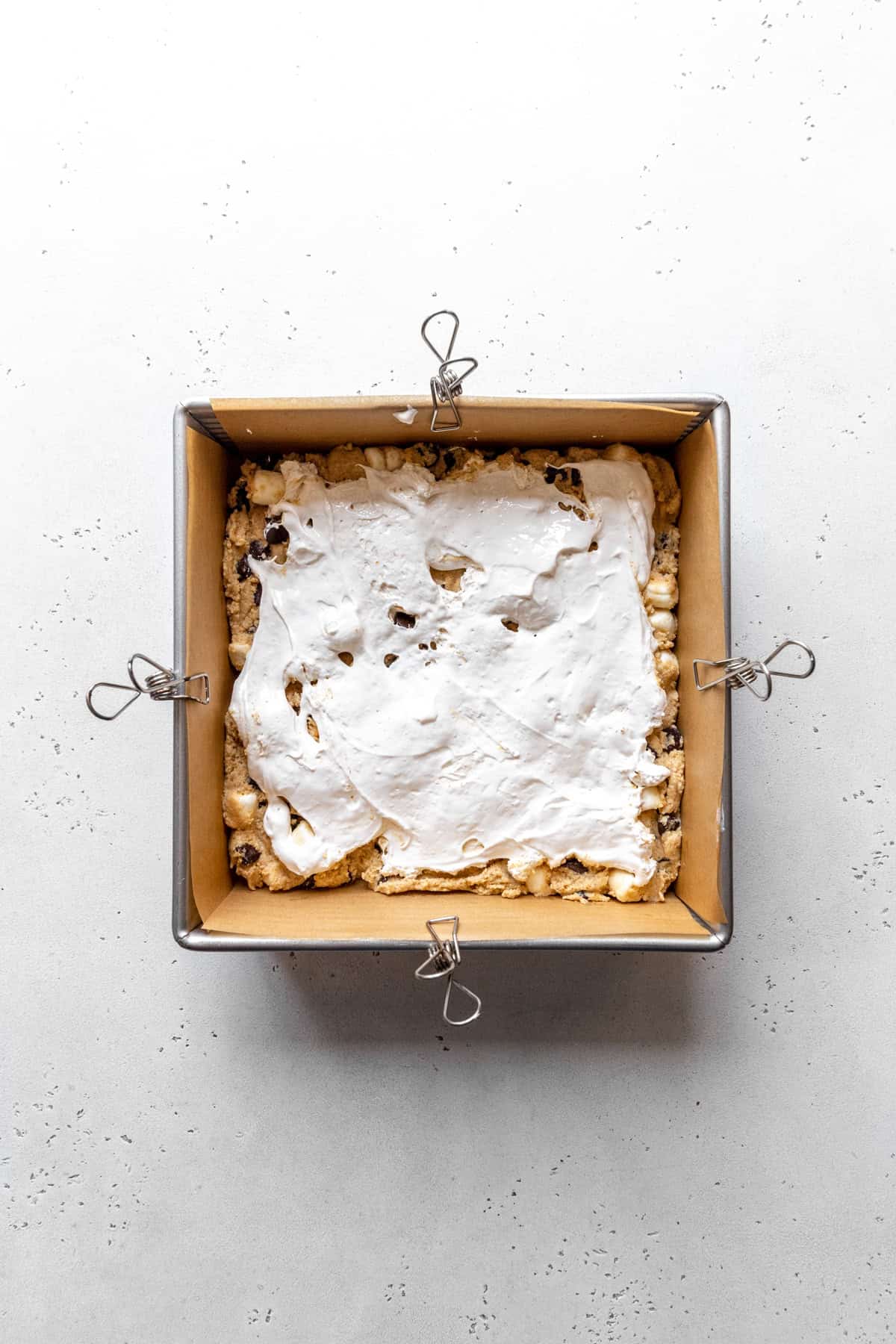 Marshmallow cream spread out in a square pan.