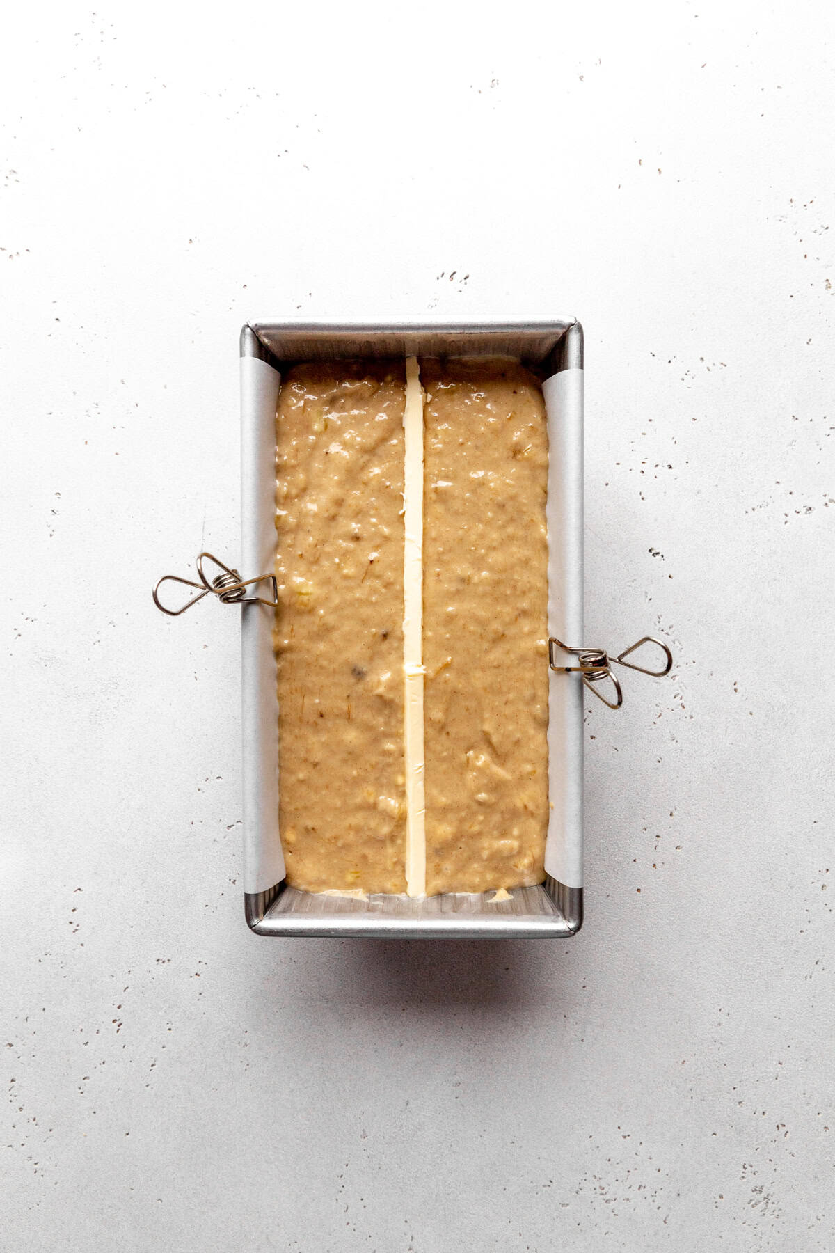 Unbaked banana bread in a loaf pan.
