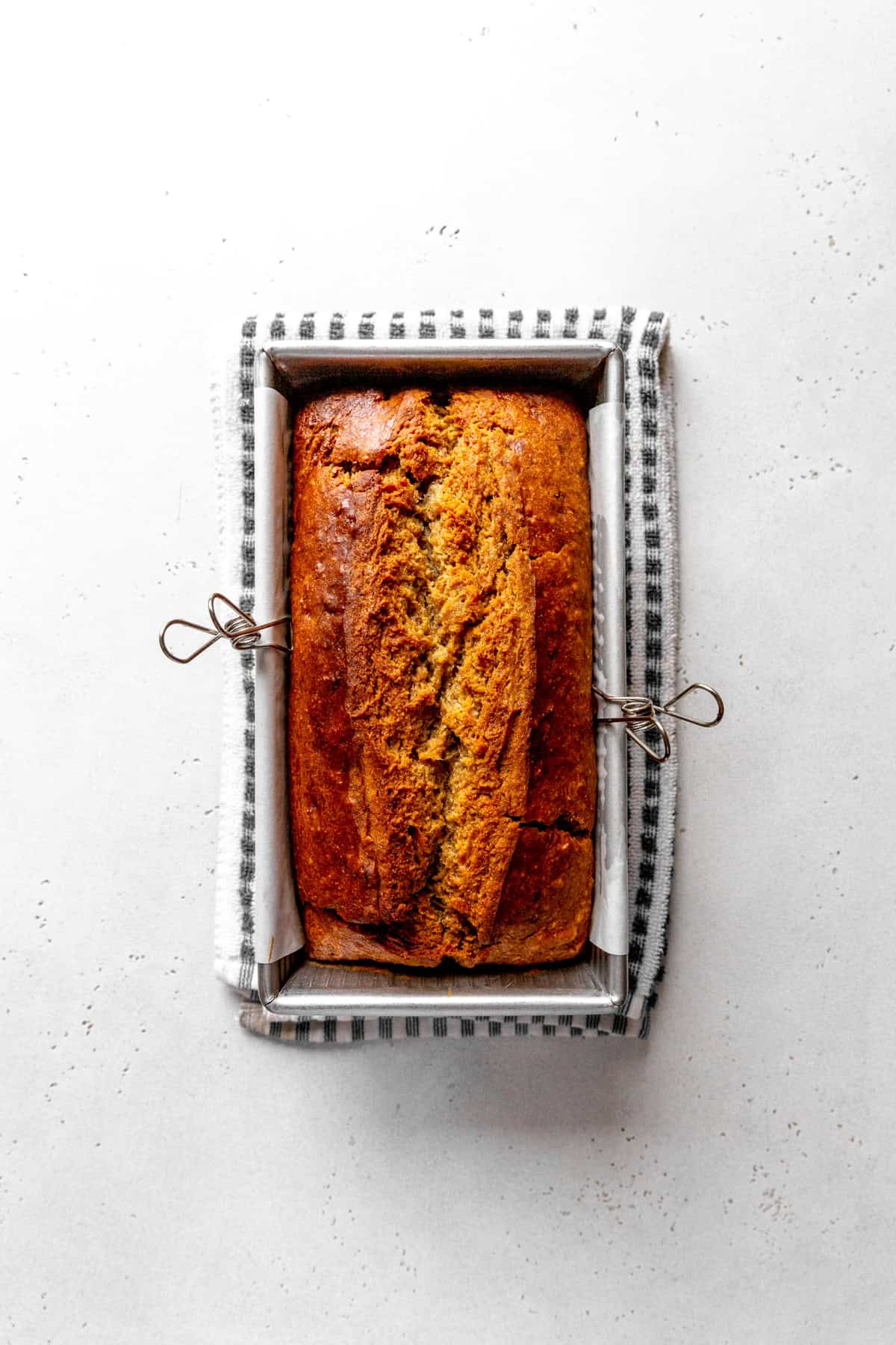 Baked banana bread in a loaf pan.
