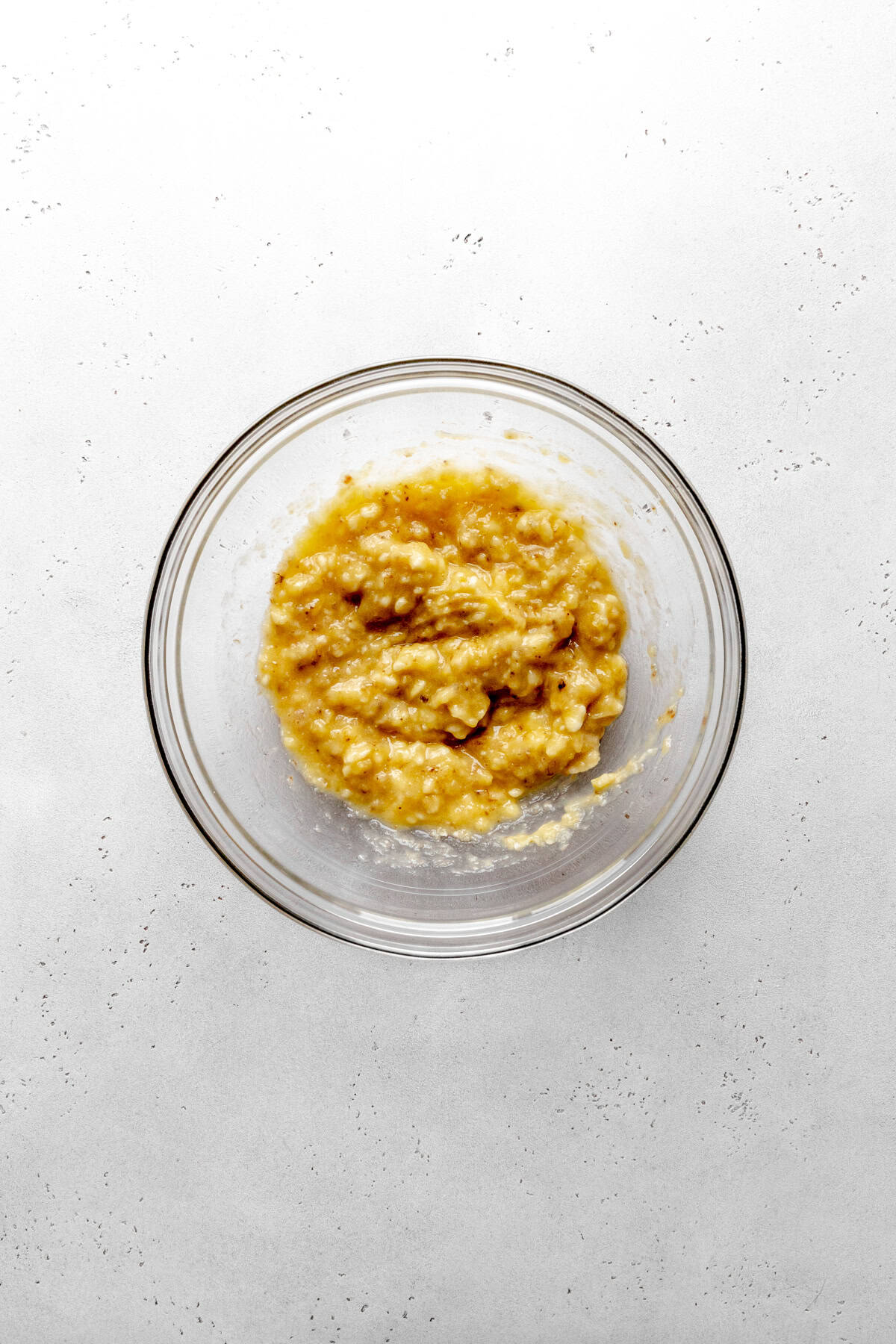 Glass bowl of mashed banana.