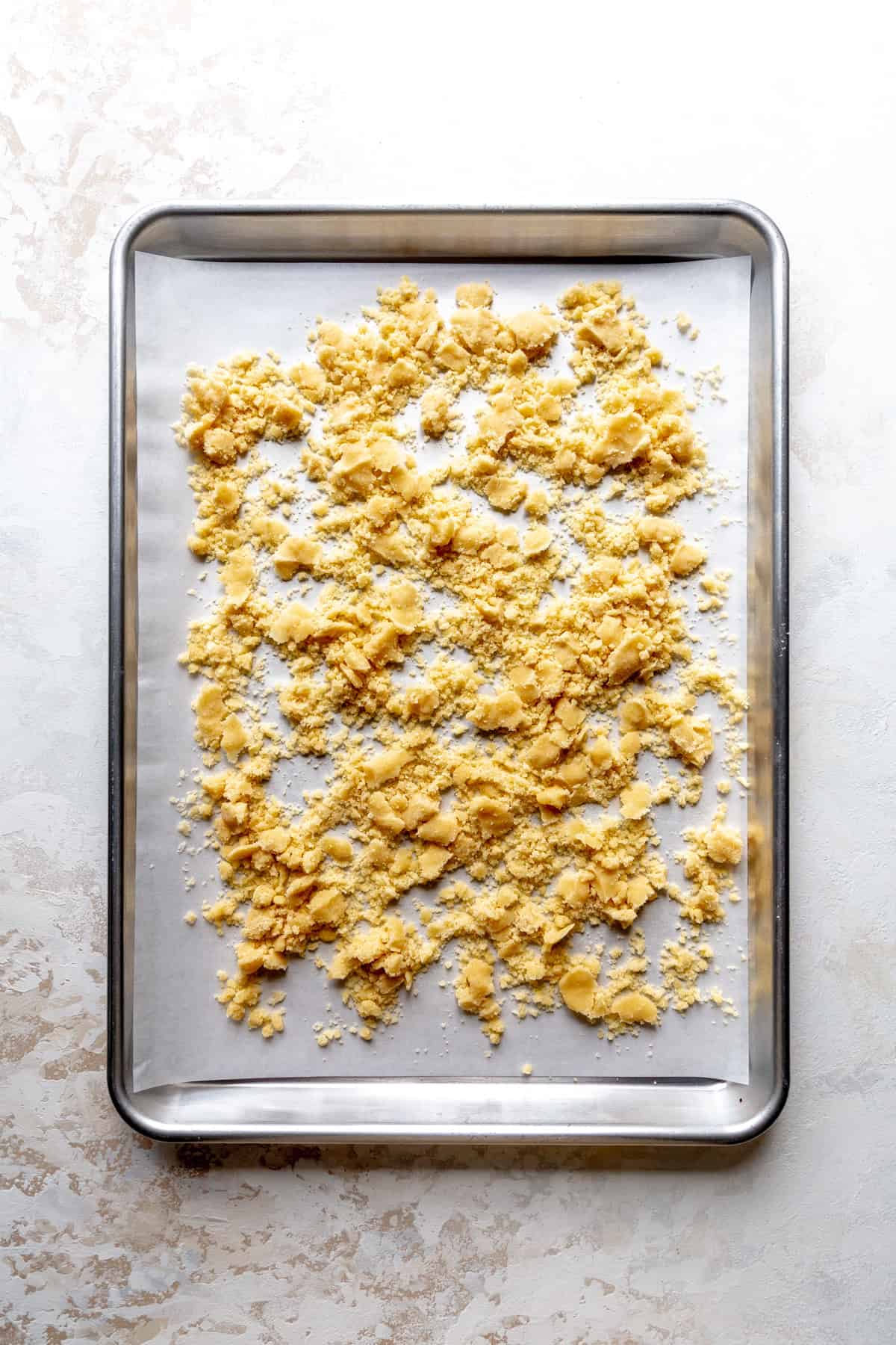 Unbaked cobbler topping on a baking sheet.