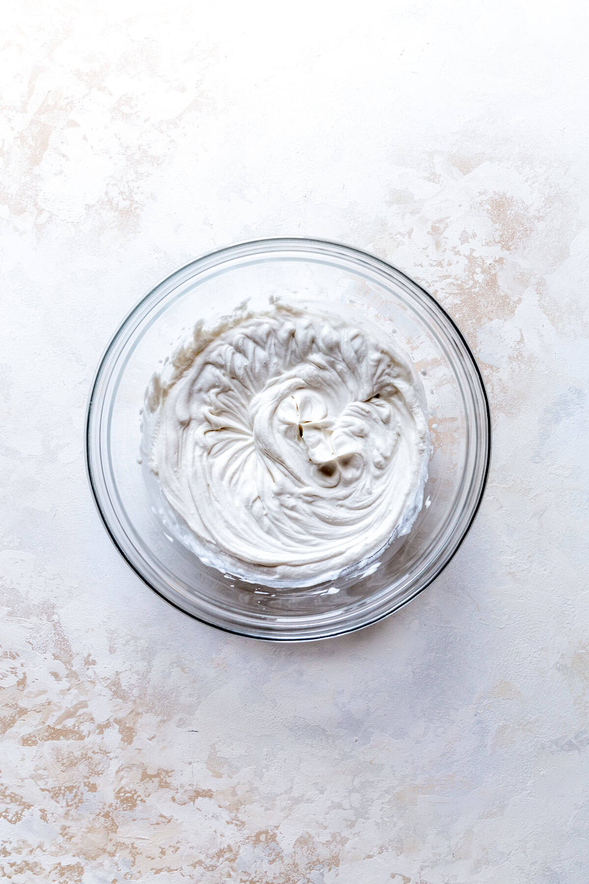 Glass bowl of whipped cream.