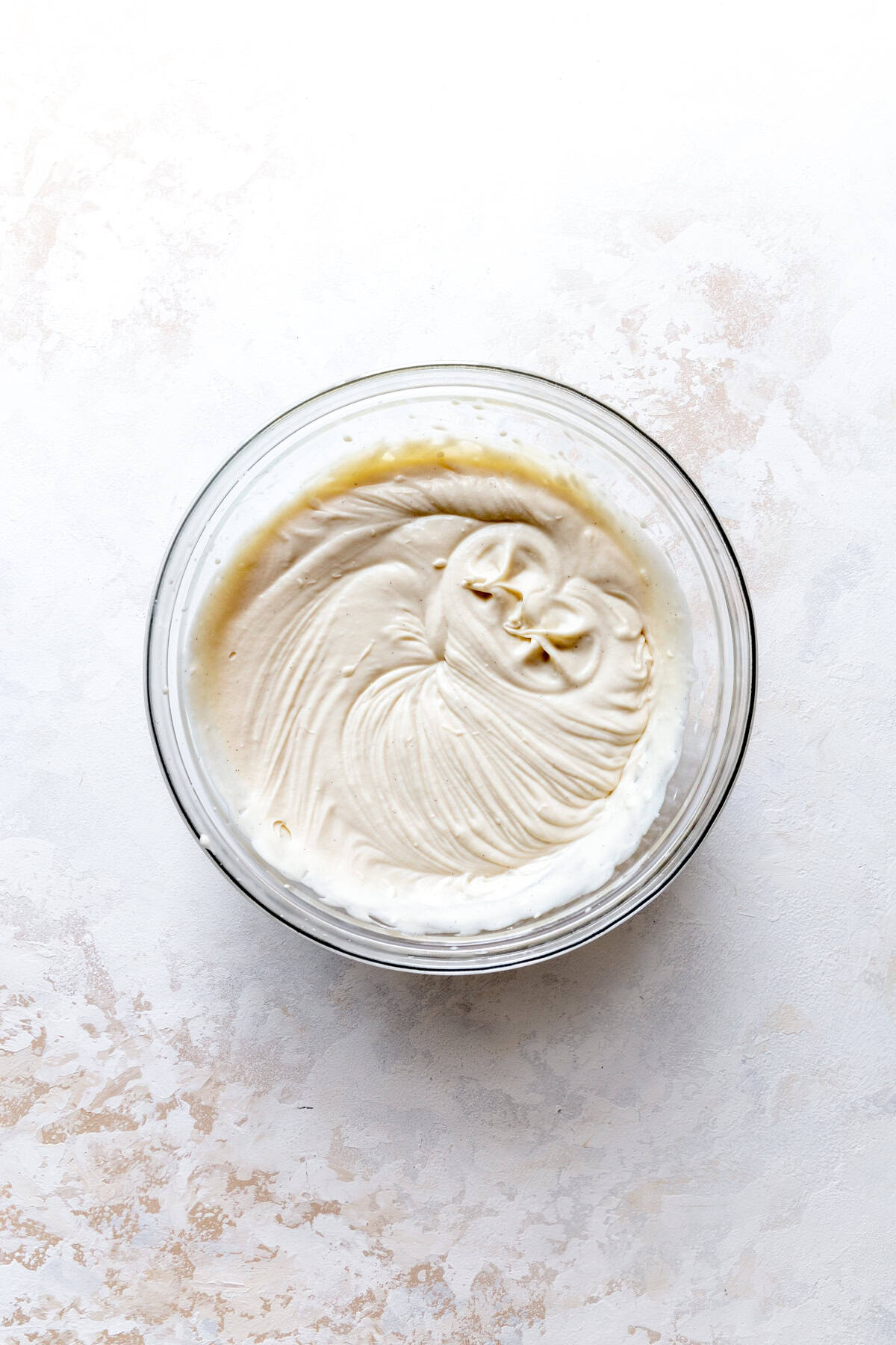 Vanilla ice cream base in a glass bowl.