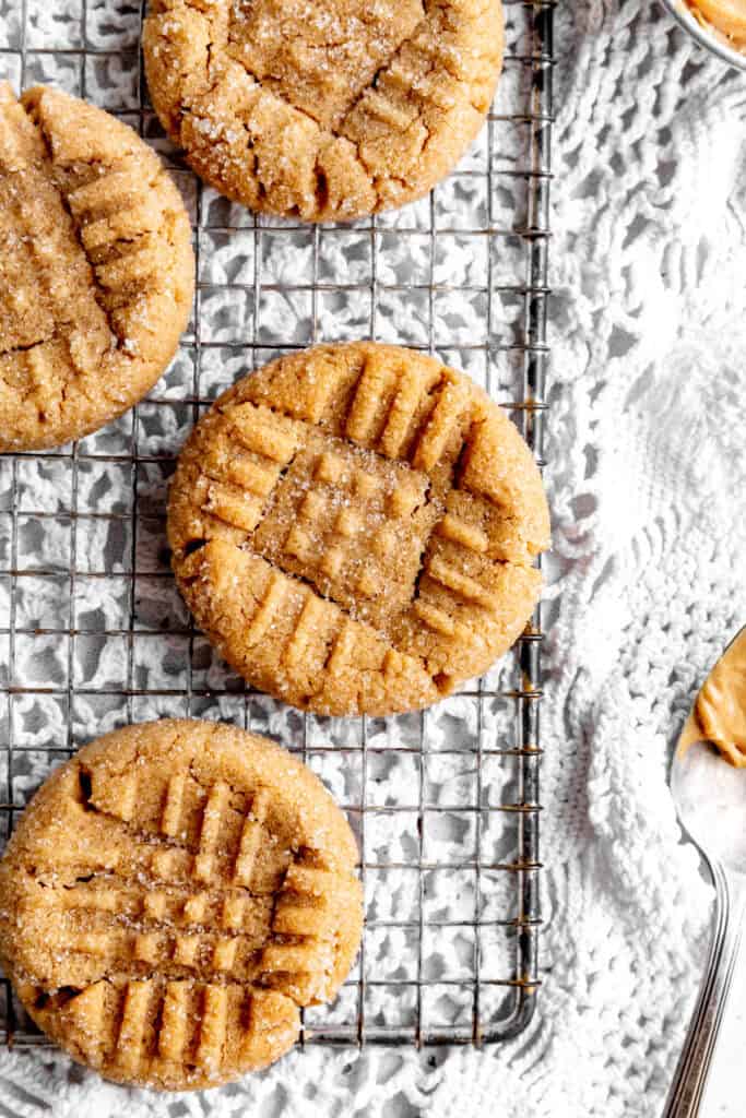 Peanut butter cookies on a wire cooling rack.