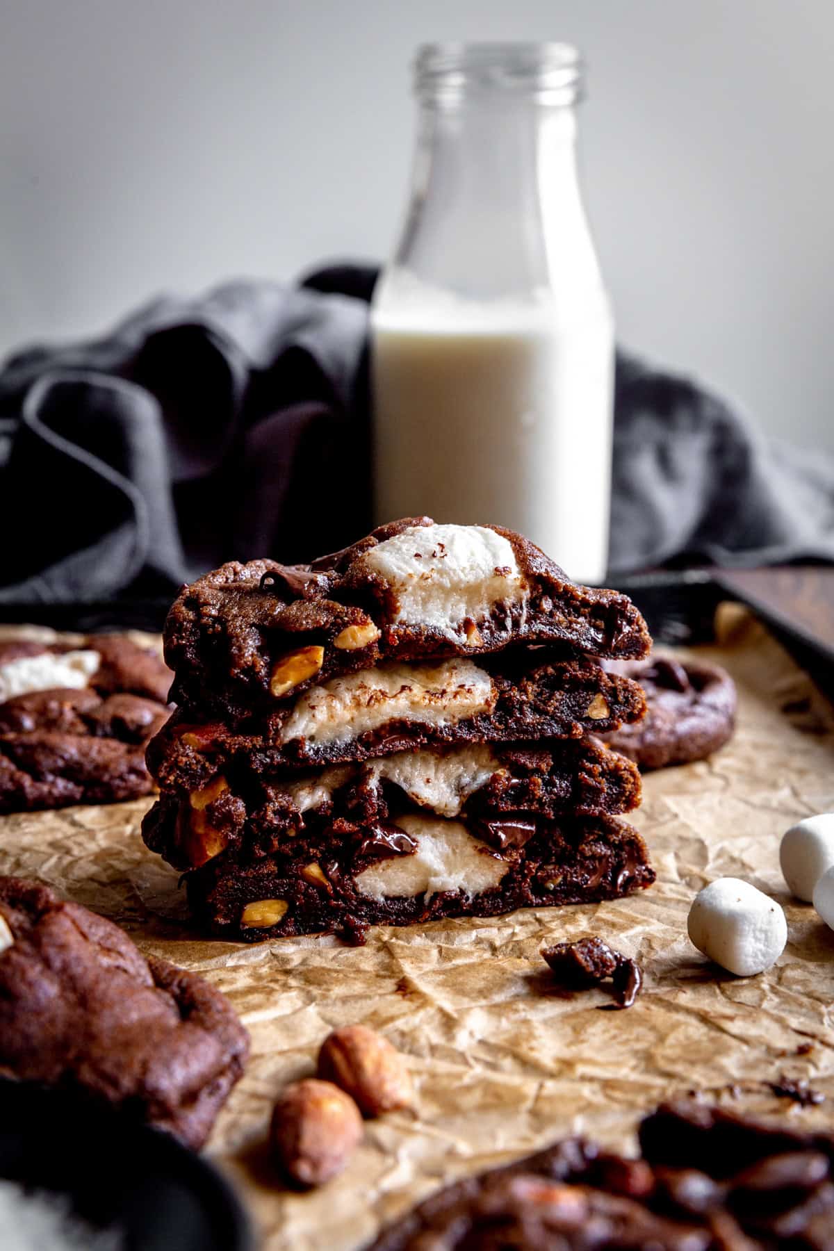 Stack of rocky road cookies and a jug of milk.