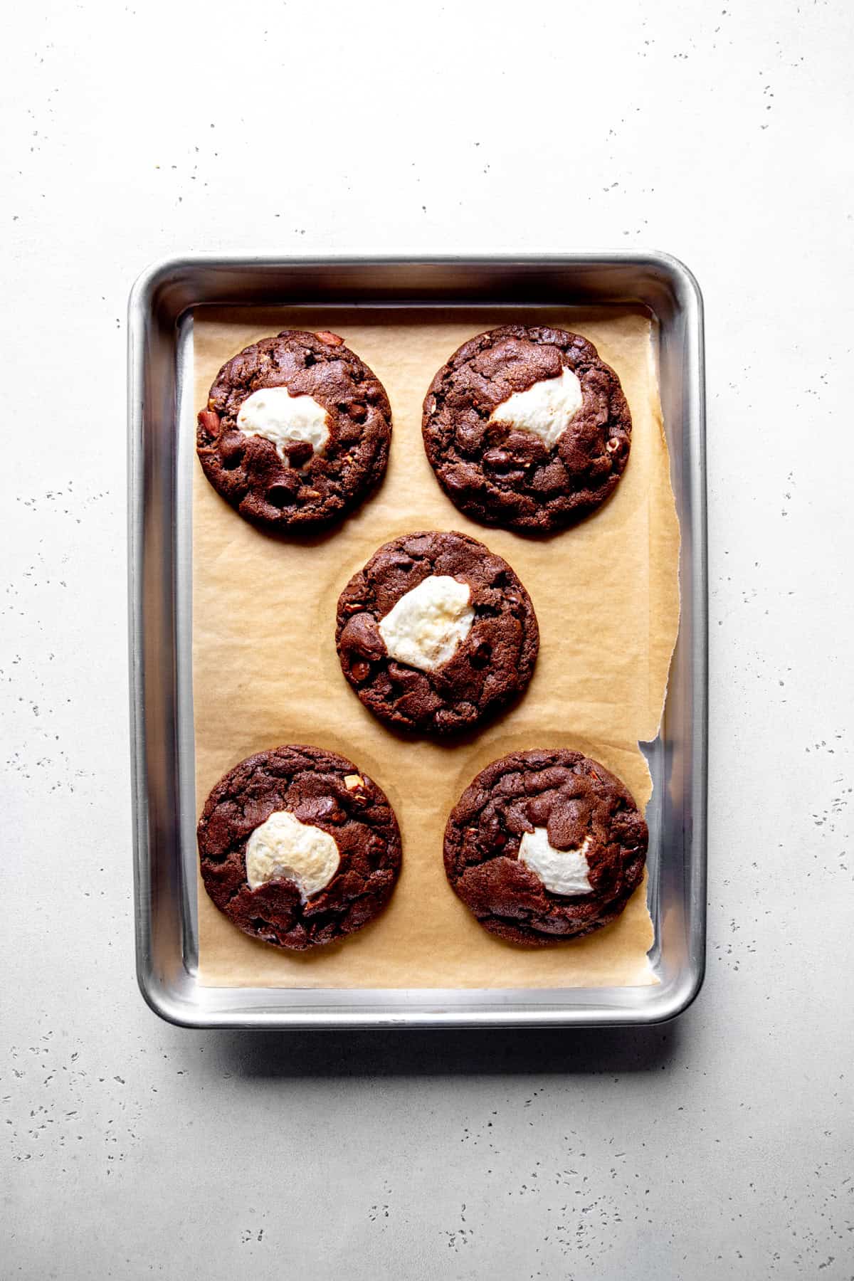 Baked rocky road cookies on a baking sheet.