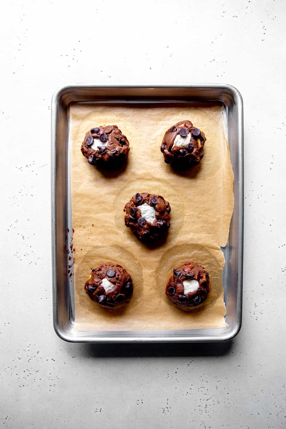 Unbaked rocky road cookies on a baking sheet.