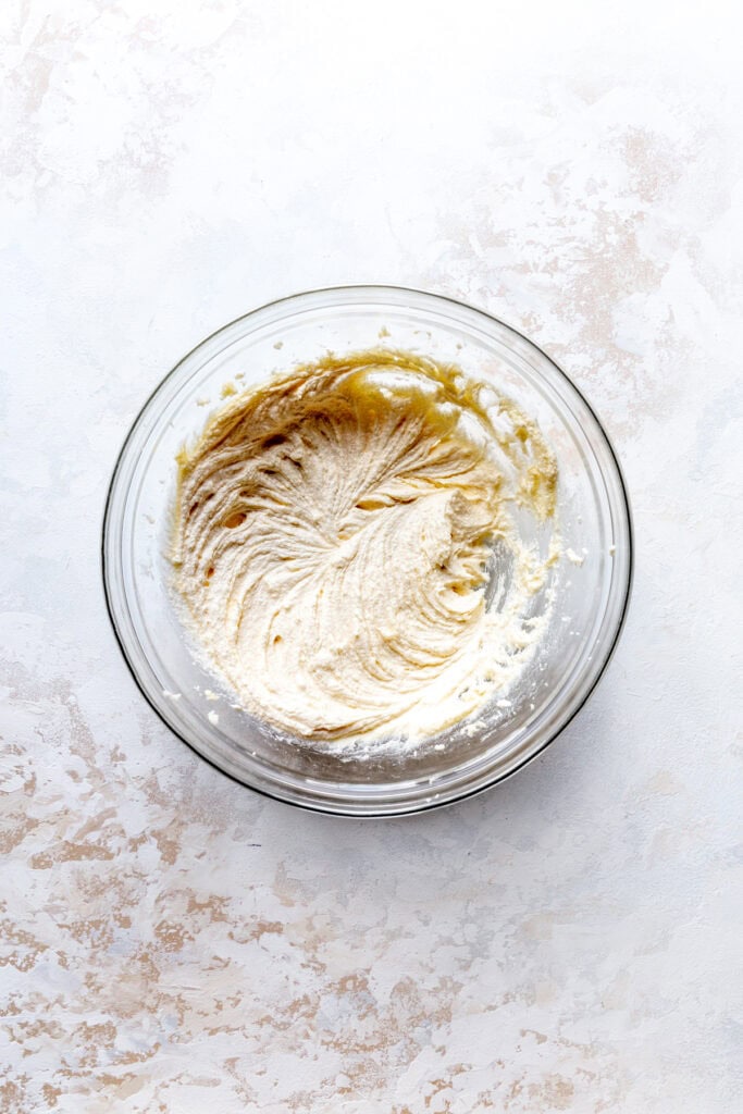 Glass bowl of creamed butter and sugar.