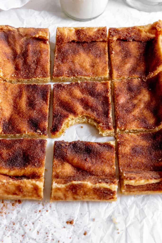 Snickerdoodle bar with a bite taken out of it surrounded by more bars.
