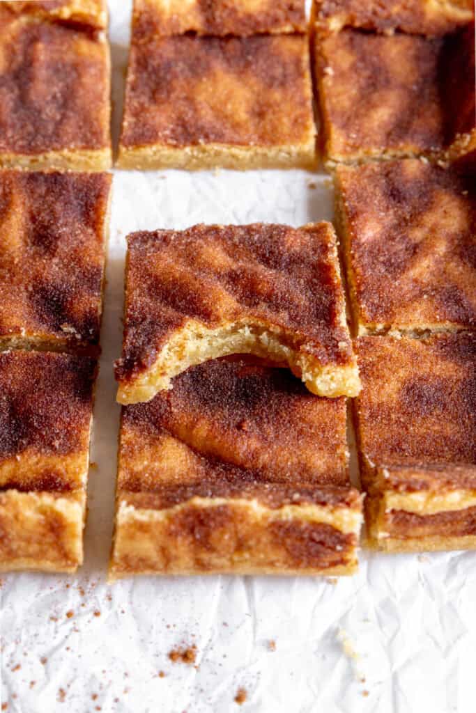 Snickerdoodle bar with a bite taken out of it propped up against other bars.