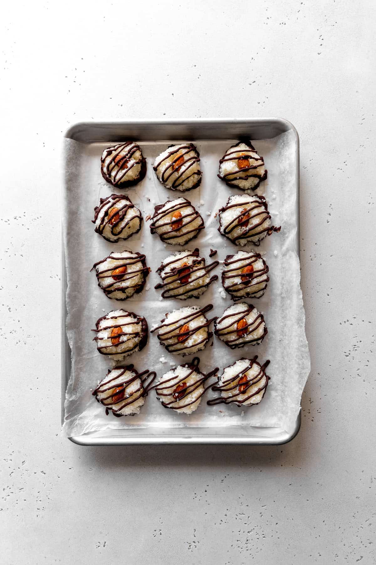 Unset almond joy bites drizzled with chocolate.