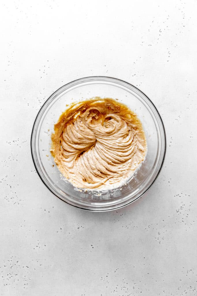 Creamed butter and sugar in a glass bowl.
