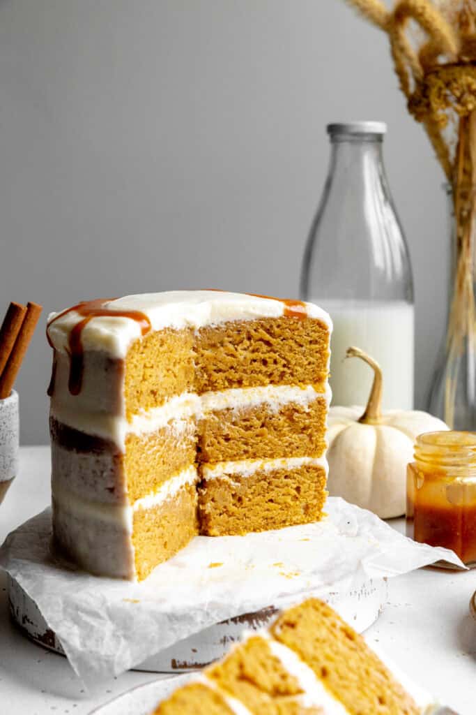 Pumpkin layer cake, a jug of milk and a white pumpkin.