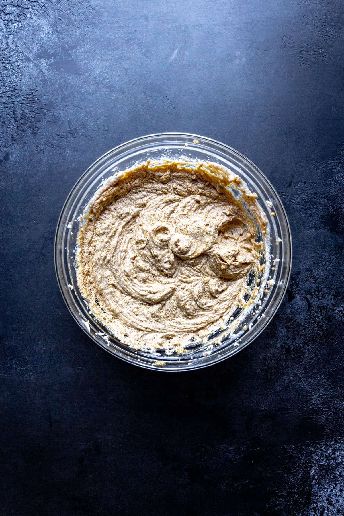 Glass bowl of creamed butter and sugar.