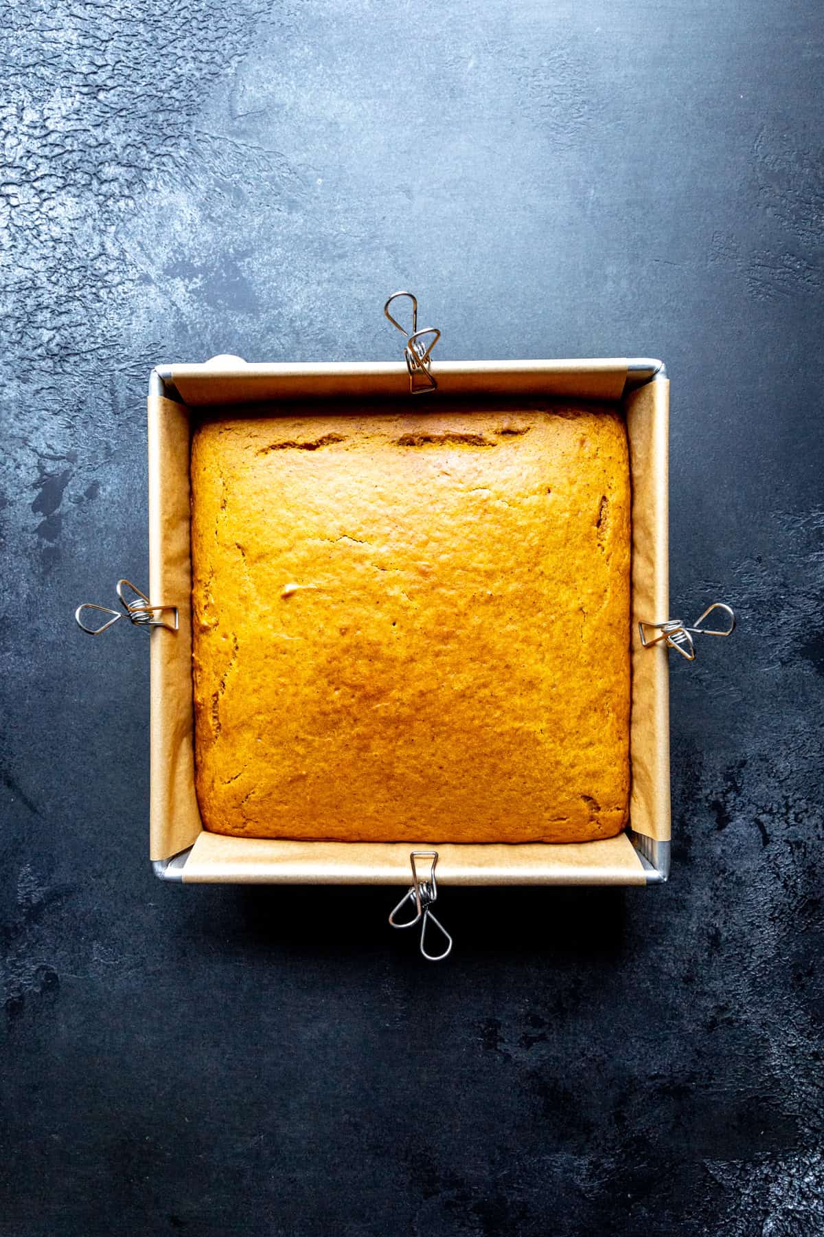 Baked pumpkin cake in a square pan.