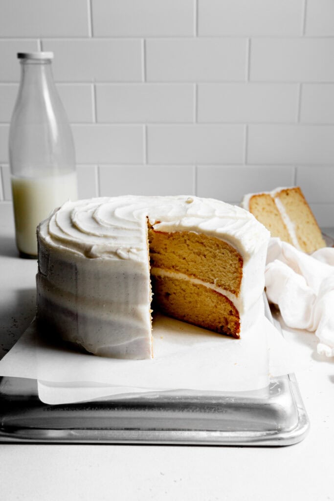 Vanilla cake with slices missing.