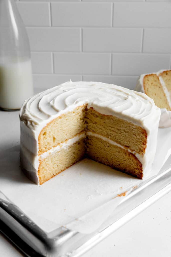 Vanilla cake with slices missing.