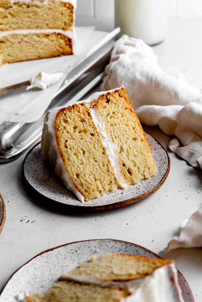 Slice of vanilla cake on a plate.