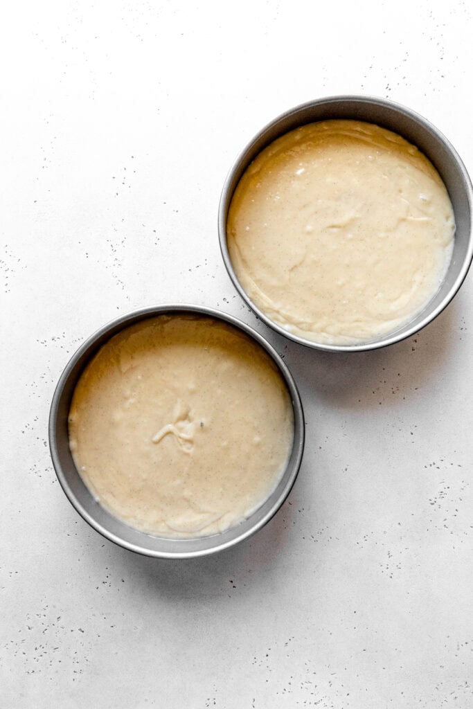 Cake batter in two round pans.