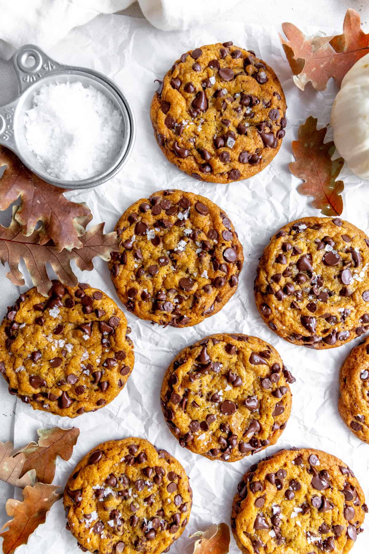 Pumpkin chocolate chip cookies, a white pumpkin and a cup of sea salt.