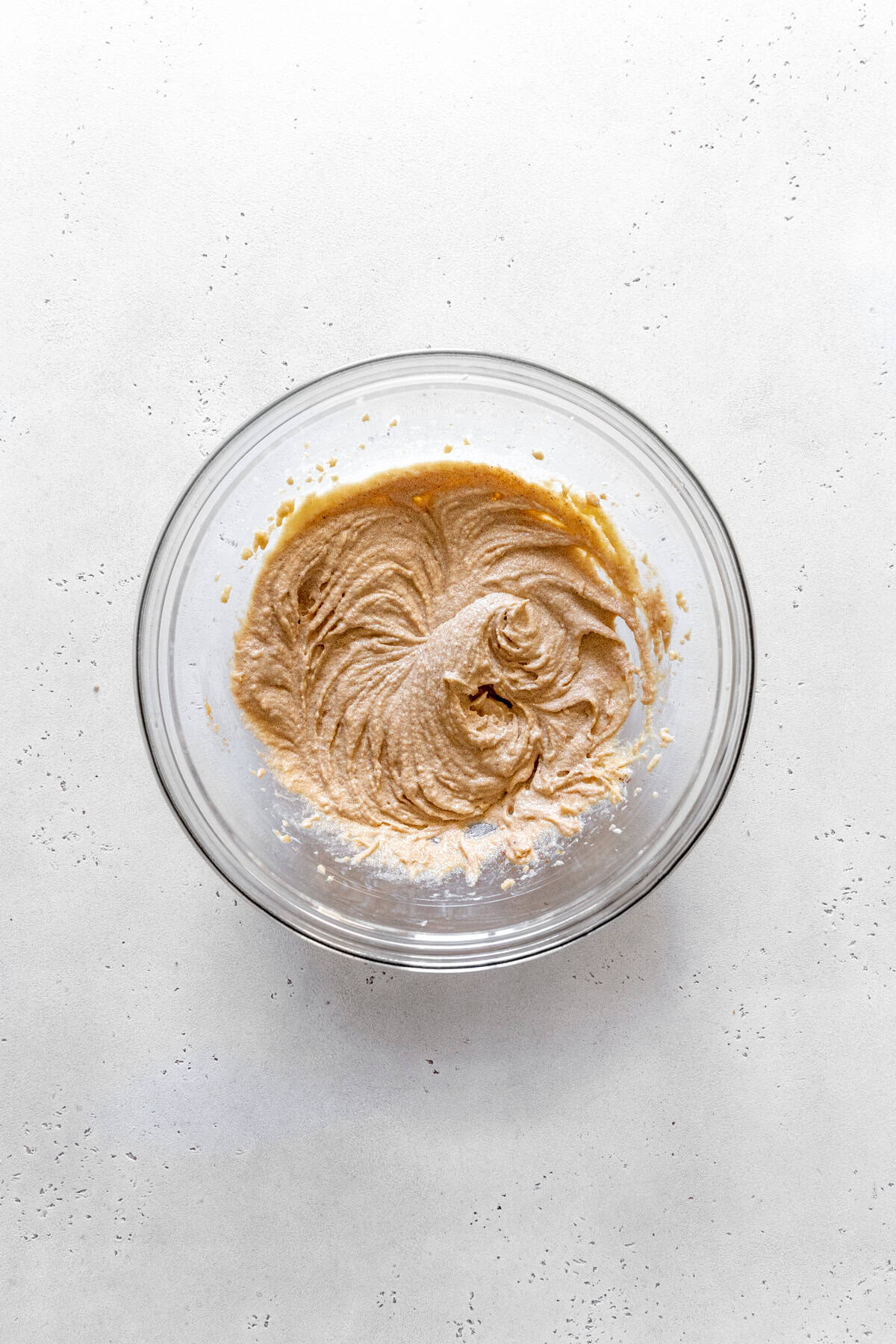 Glass bowl of creamed butter and sugar.