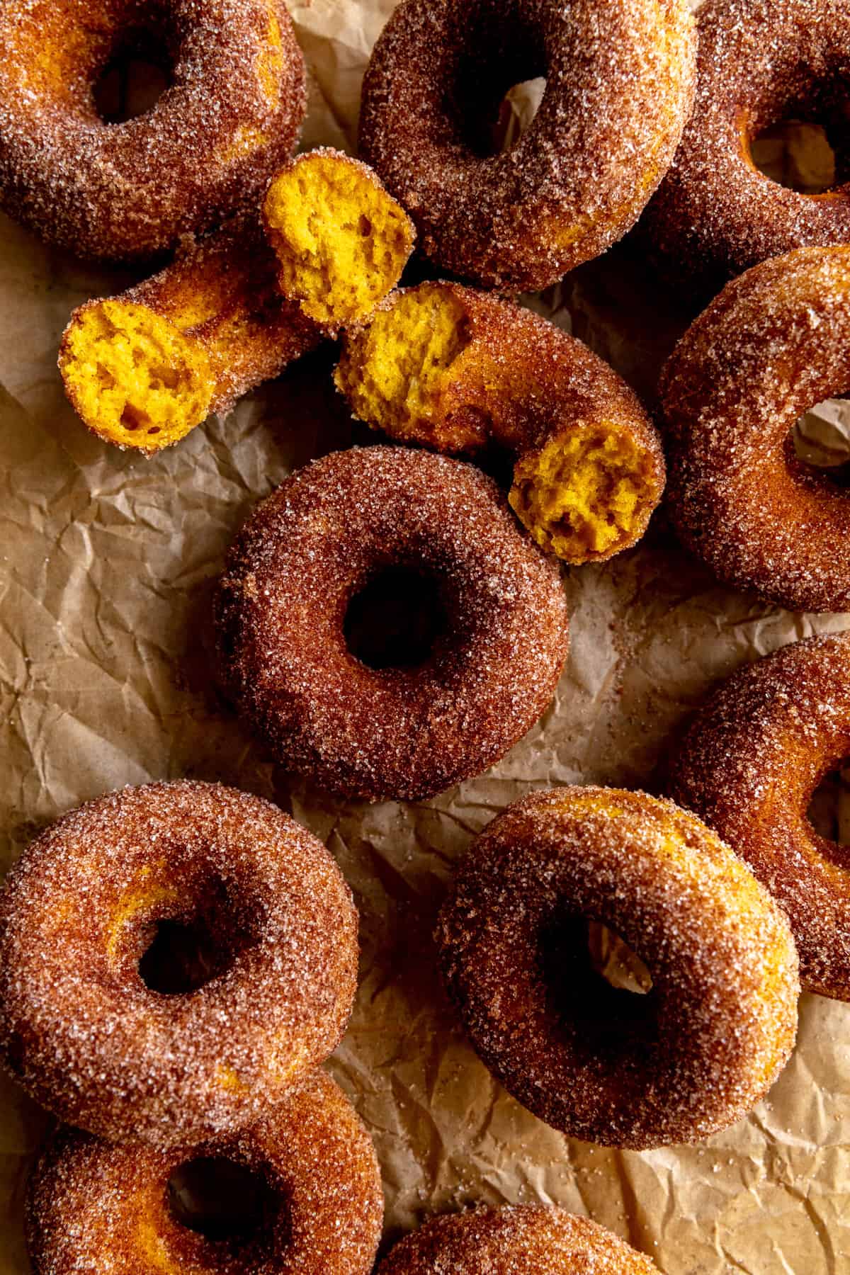 Pumpkin donuts on parchment paper.