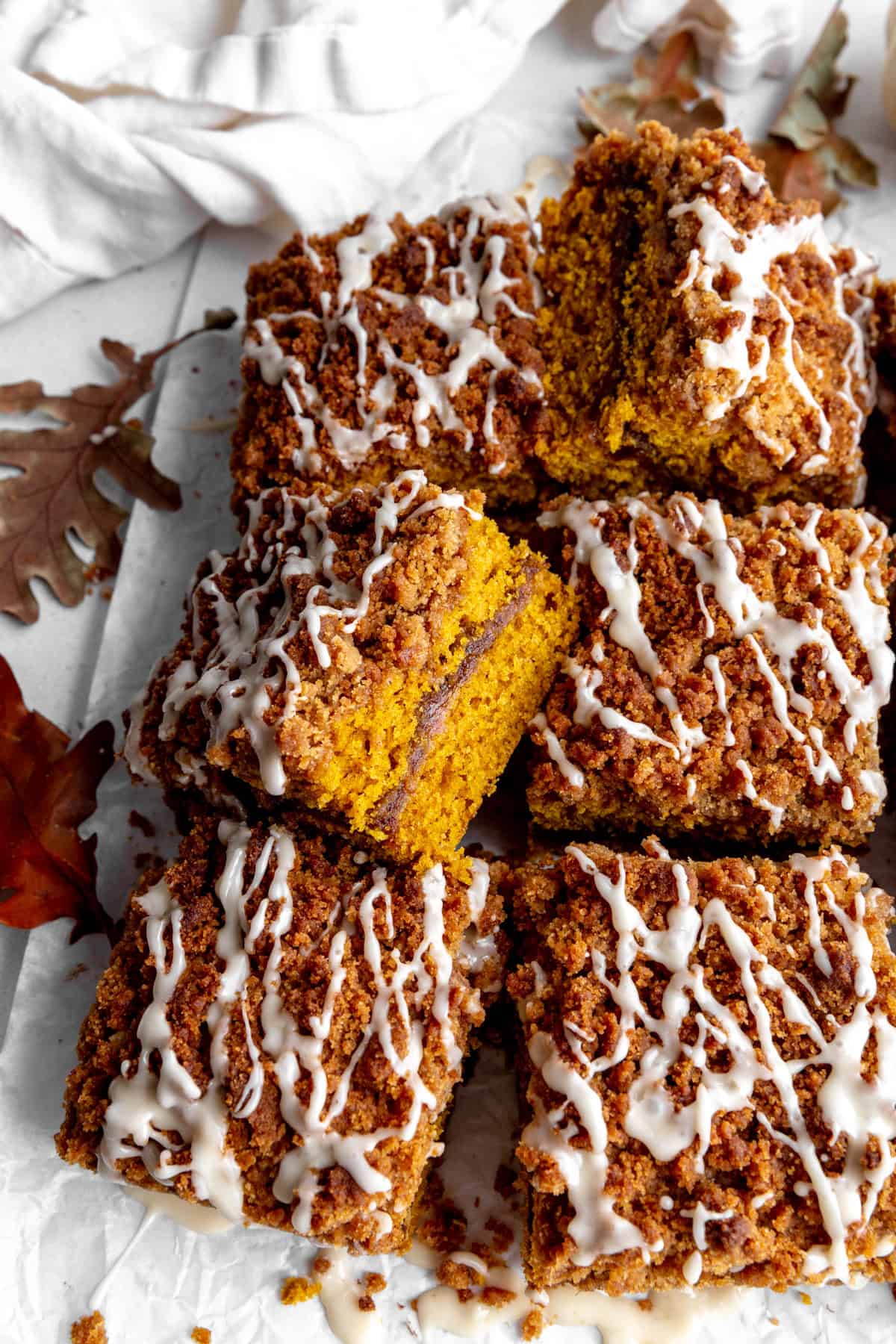 Sliced pumpkin coffee cake and a linen napkin.