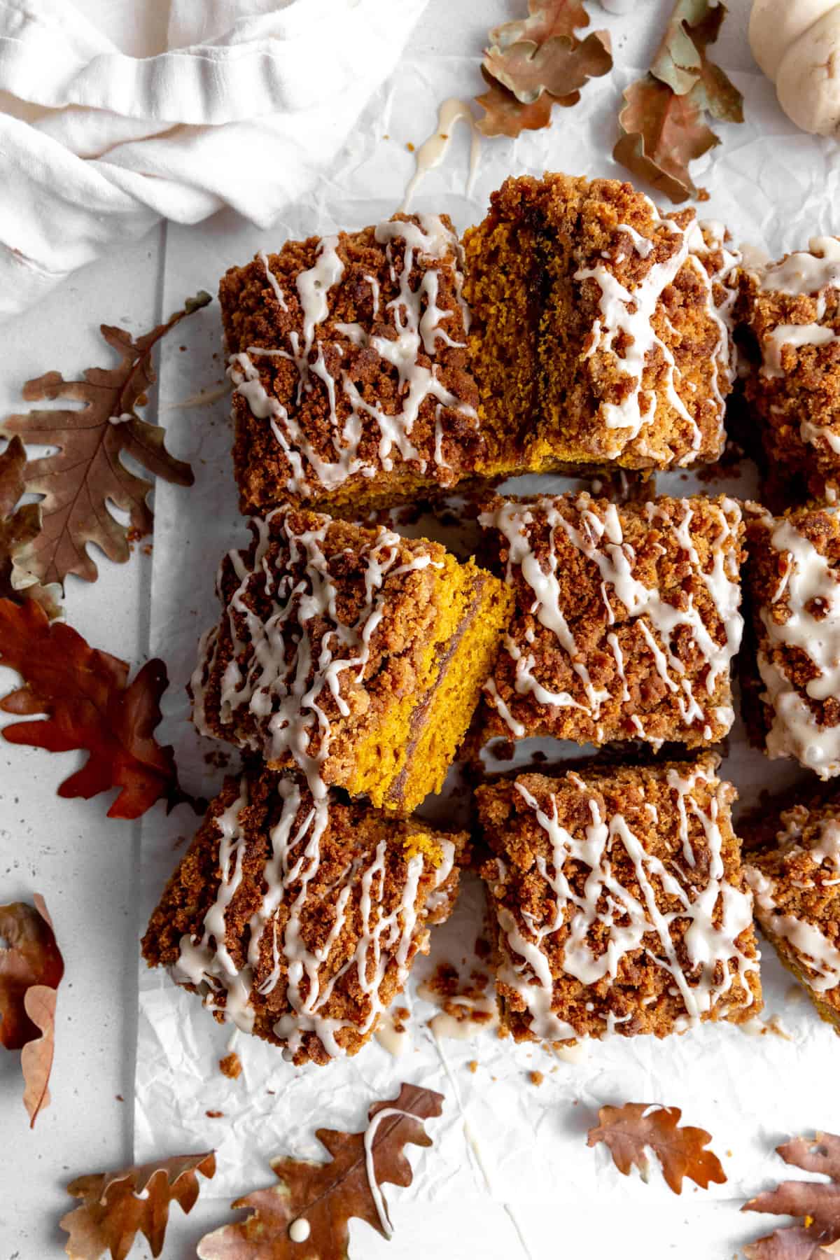 Sliced pumpkin coffee cake and a linen napkin.