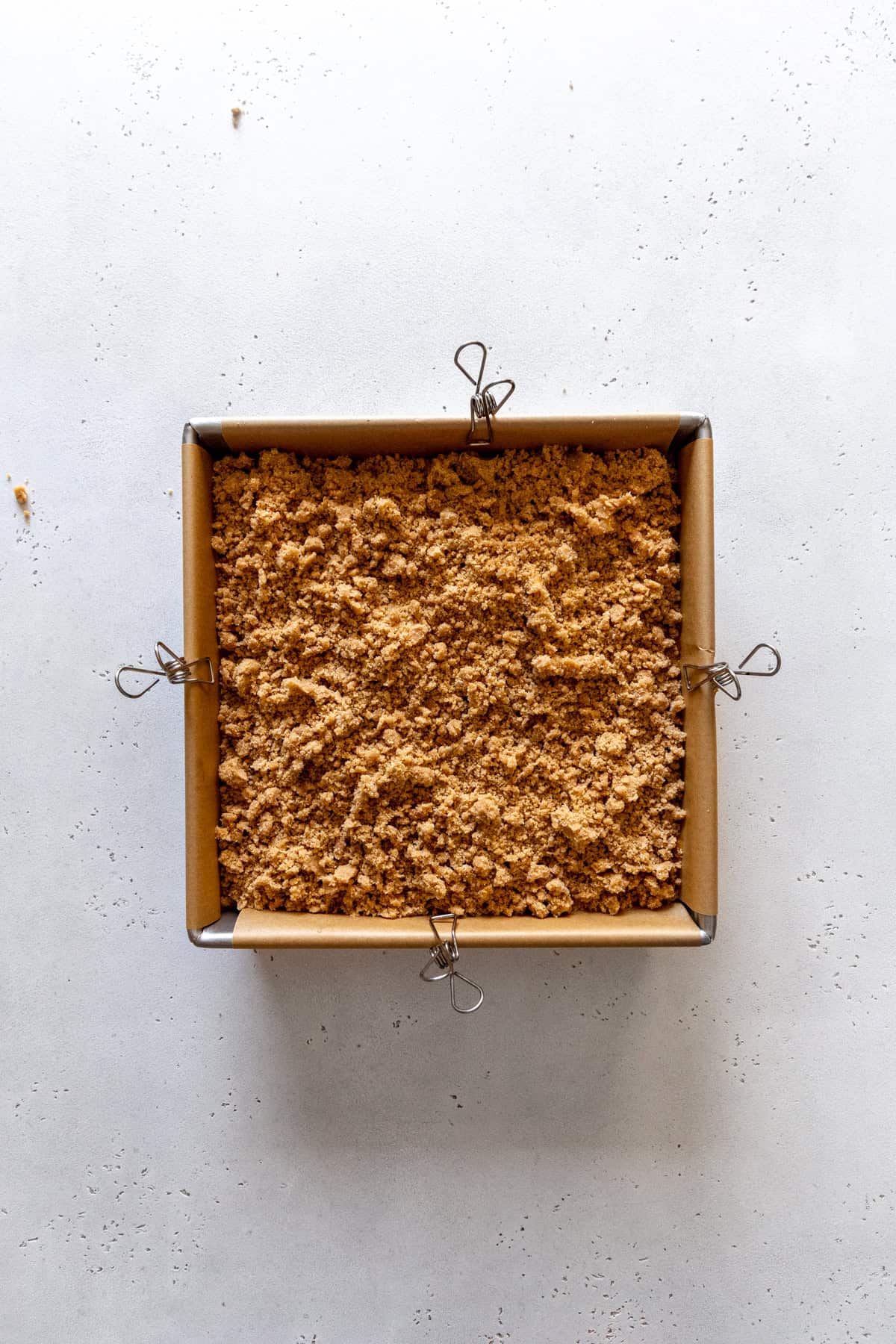 Unbaked pumpkin coffee cake in a square pan.