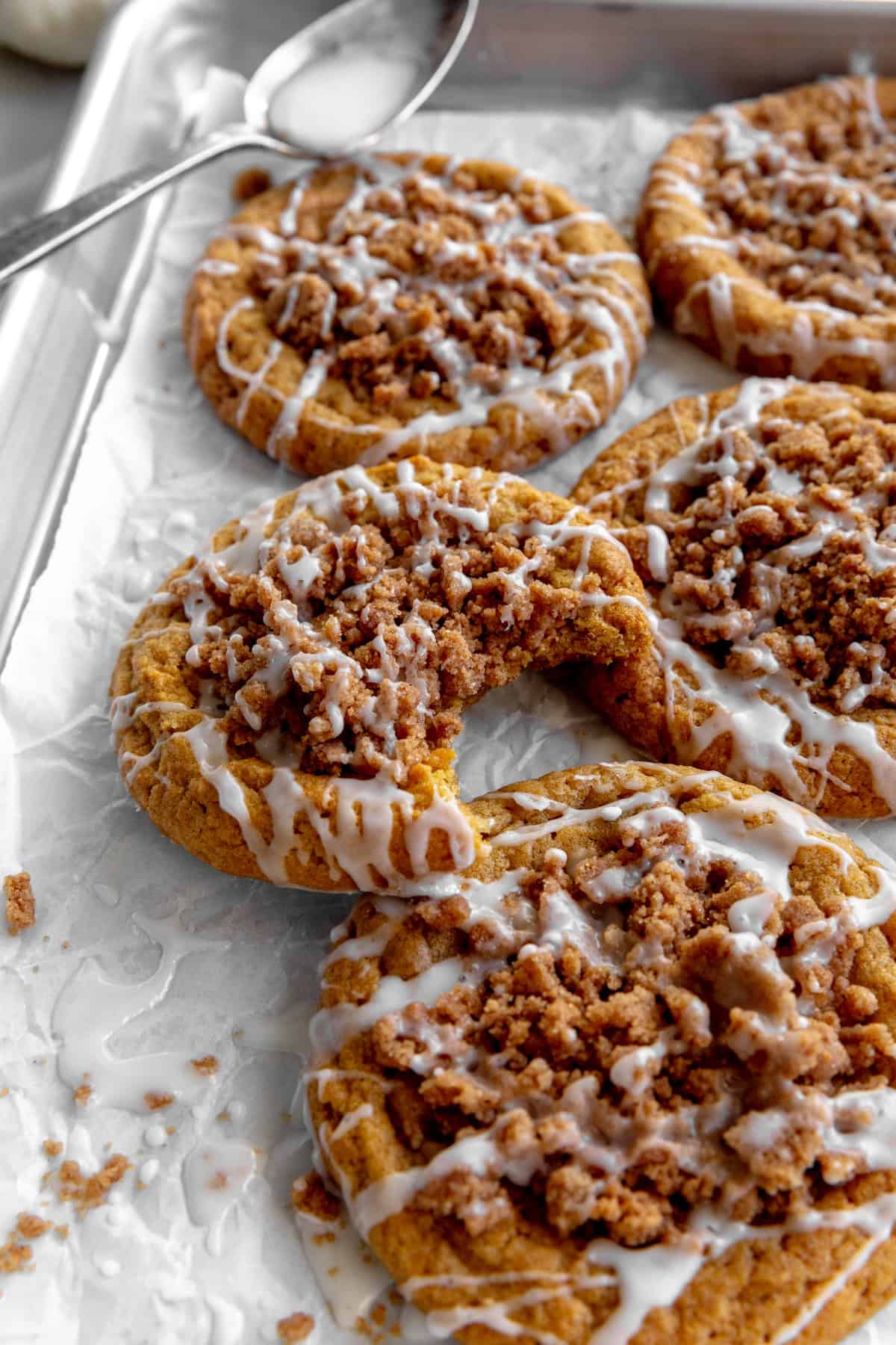 Pumpkin coffee cake cookie with a bite taken out of it.