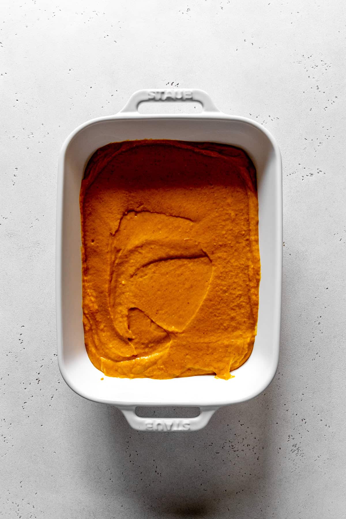 Pumpkin custard filling in a baking dish.